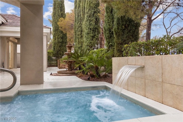 view of swimming pool with pool water feature