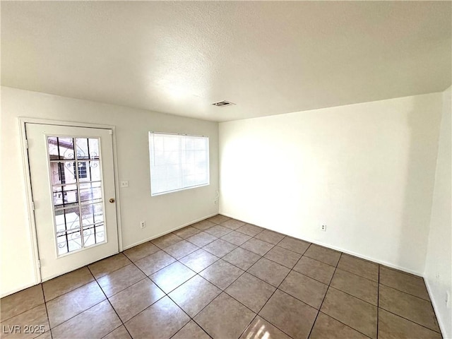 empty room with tile patterned floors