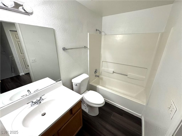 full bathroom featuring toilet, vanity, shower / bathing tub combination, and wood-type flooring