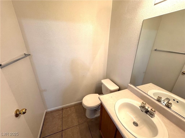 bathroom with vanity, toilet, and tile patterned floors