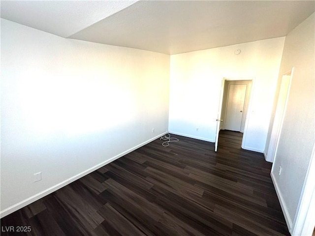 unfurnished room with dark hardwood / wood-style floors