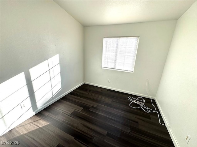 empty room featuring dark wood-type flooring