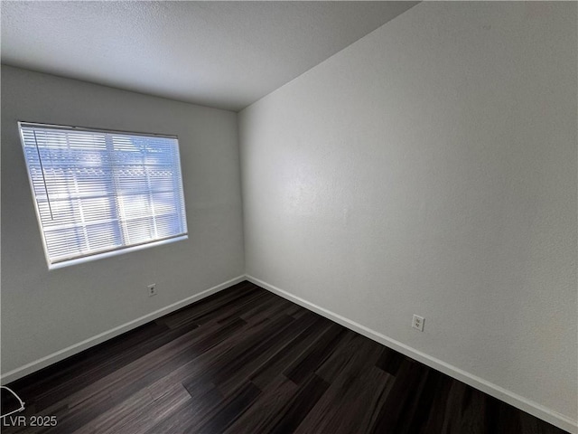 empty room featuring dark wood-type flooring