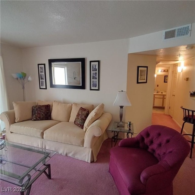 living room featuring light carpet and a textured ceiling