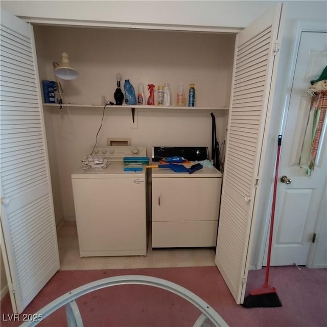 clothes washing area with washing machine and dryer