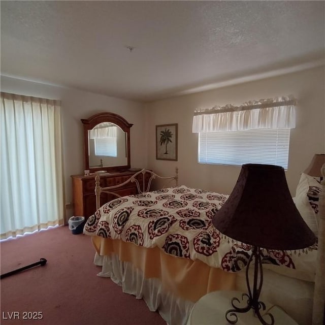 carpeted bedroom featuring a textured ceiling