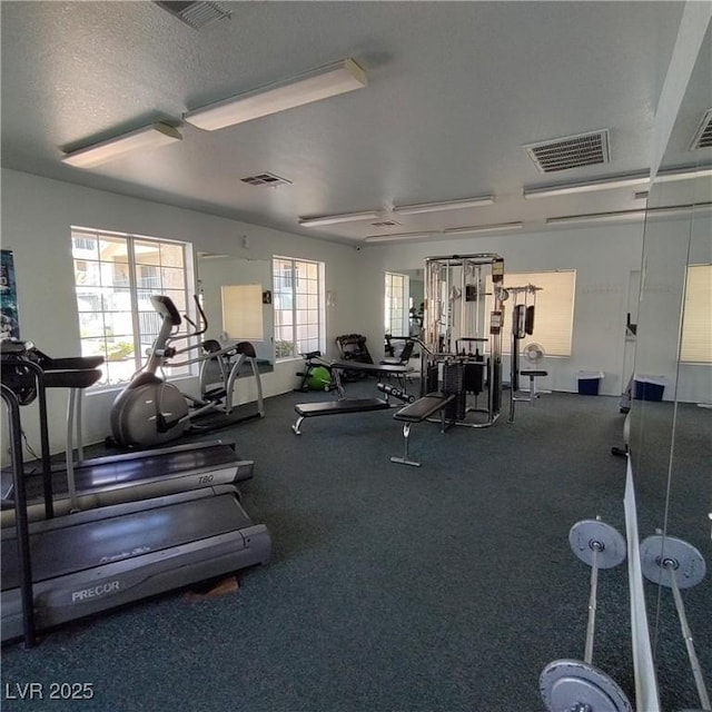 exercise room with a textured ceiling