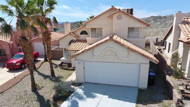 view of front facade featuring a garage and a mountain view