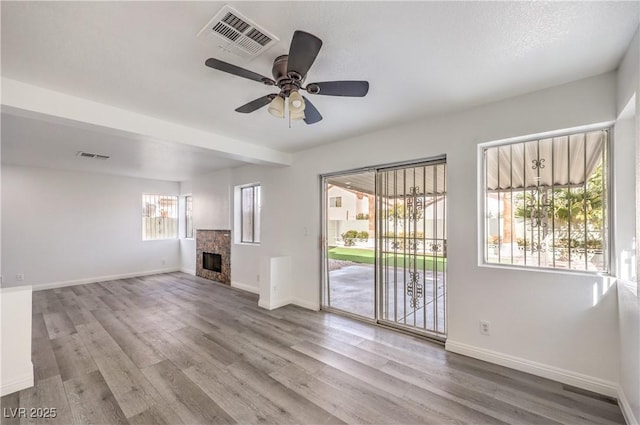 unfurnished living room featuring ceiling fan and light wood-type flooring