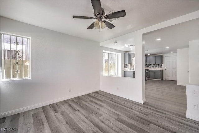 spare room featuring ceiling fan and light hardwood / wood-style floors