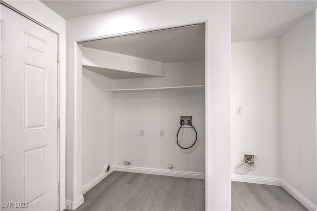 laundry room featuring gas dryer hookup, hookup for a washing machine, light hardwood / wood-style floors, and electric dryer hookup