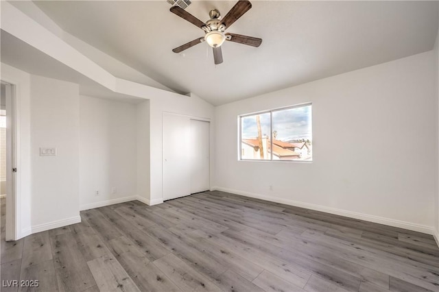 interior space with ceiling fan, lofted ceiling, and light hardwood / wood-style floors