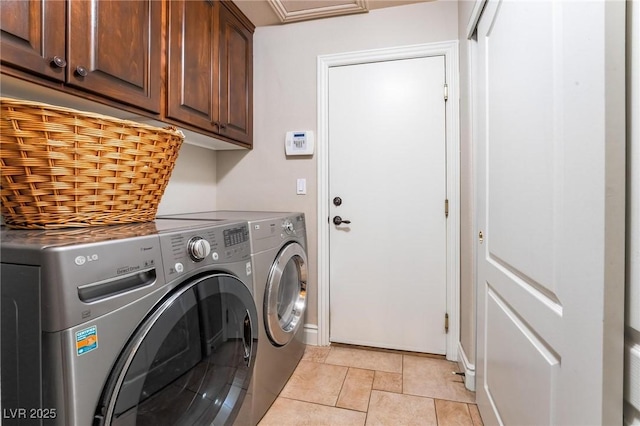 clothes washing area featuring cabinets and washing machine and clothes dryer