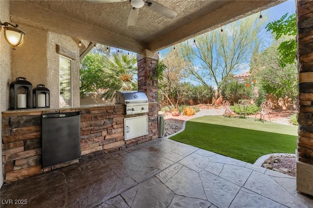 view of patio / terrace featuring ceiling fan, grilling area, and exterior kitchen