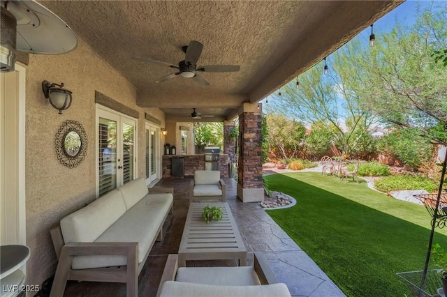 view of patio / terrace featuring area for grilling, outdoor lounge area, and ceiling fan