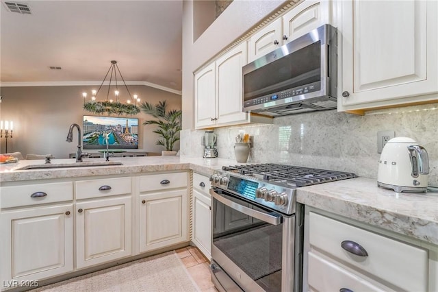 kitchen with decorative light fixtures, tasteful backsplash, sink, stainless steel appliances, and crown molding