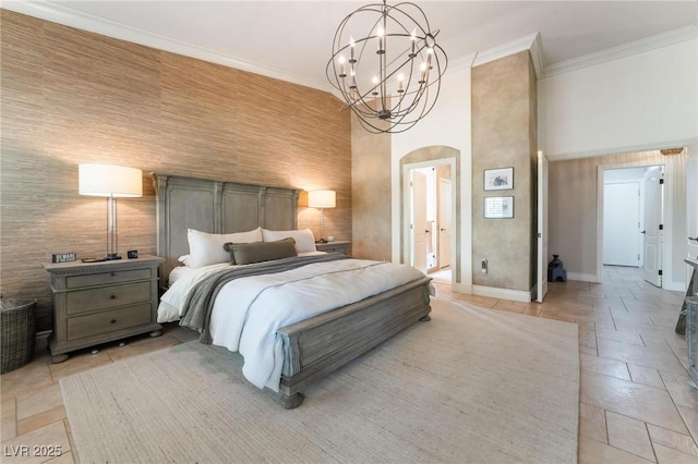 bedroom featuring crown molding, a towering ceiling, and a chandelier