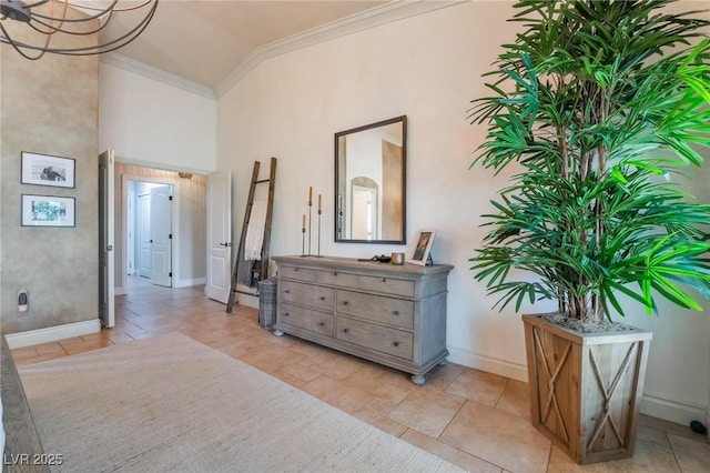 hallway featuring crown molding and high vaulted ceiling