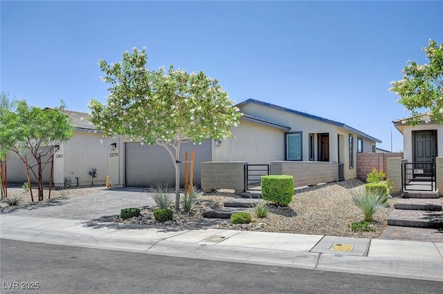 2379 Albury Ave, North Las Vegas, NV 89086 - view of front of property featuring a garage, a gate, stucco siding, and driveway