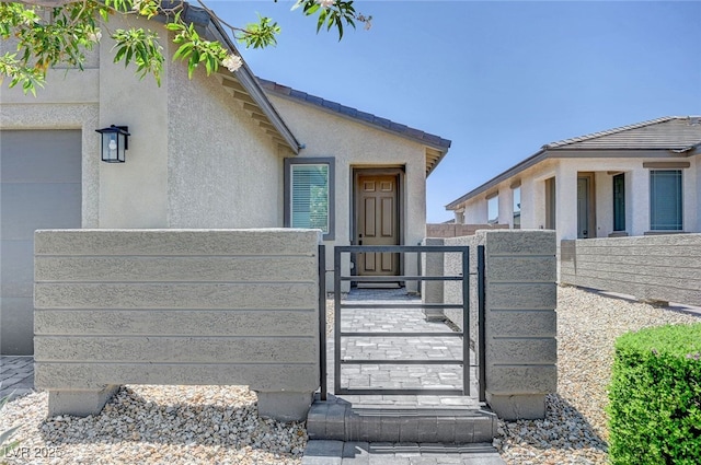 2379 Albury Ave, North Las Vegas, NV 89086 - view of exterior entry featuring a gate and stucco siding
