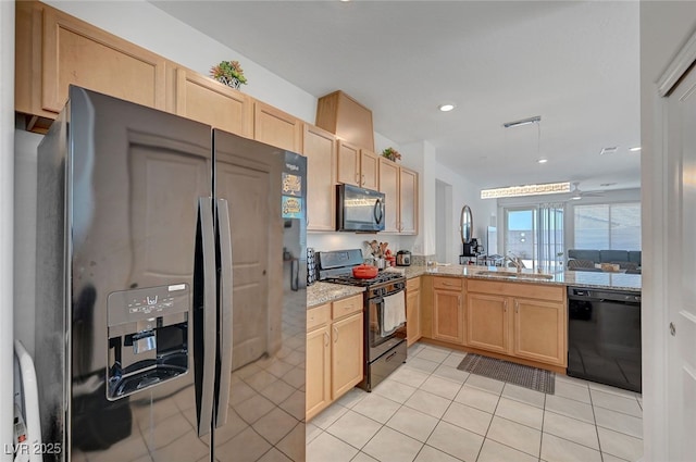 2379 Albury Ave, North Las Vegas, NV 89086 - kitchen featuring black appliances, light brown cabinets, light tile patterned floors, light stone counters, and recessed lighting