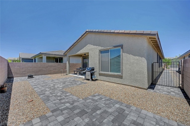 2379 Albury Ave, North Las Vegas, NV 89086 - rear view of house featuring a fenced backyard, a patio, stucco siding, and a gate