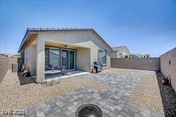 2379 Albury Ave, North Las Vegas, NV 89086 - rear view of property featuring a patio, a fire pit, a fenced backyard, and stucco siding
