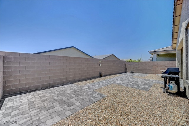 2379 Albury Ave, North Las Vegas, NV 89086 - fenced backyard with a patio and a grill