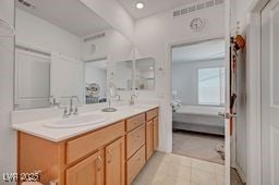 2379 Albury Ave, North Las Vegas, NV 89086 - bathroom with ensuite bath, double vanity, tile patterned flooring, and recessed lighting