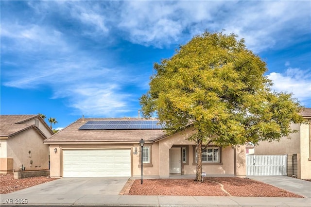 view of front of property with a garage and solar panels