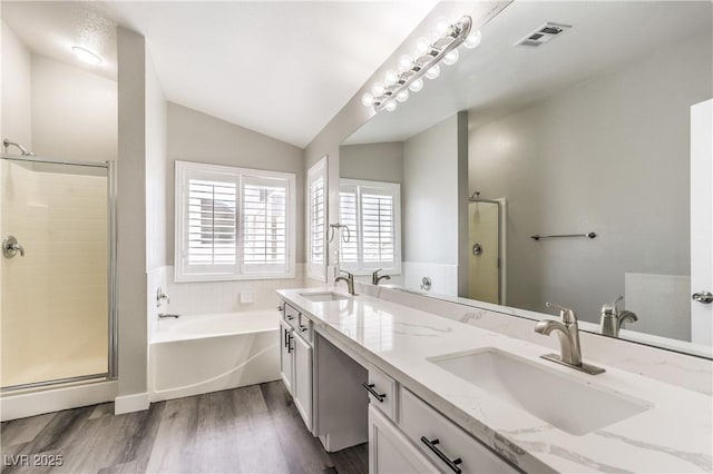 bathroom with lofted ceiling, hardwood / wood-style floors, vanity, and independent shower and bath