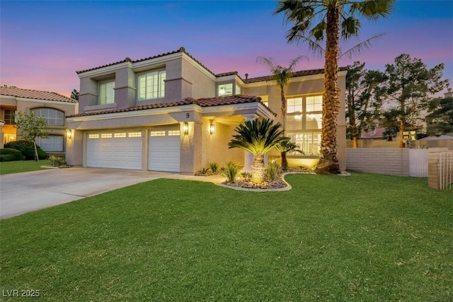 mediterranean / spanish house with a garage and a lawn