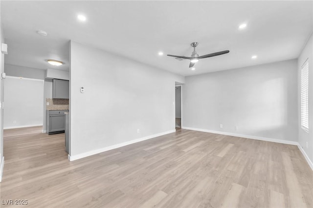 spare room featuring ceiling fan and light hardwood / wood-style flooring