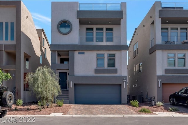 contemporary home featuring cooling unit and a garage