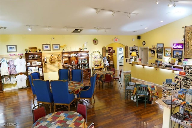 interior space featuring dark hardwood / wood-style flooring and vaulted ceiling