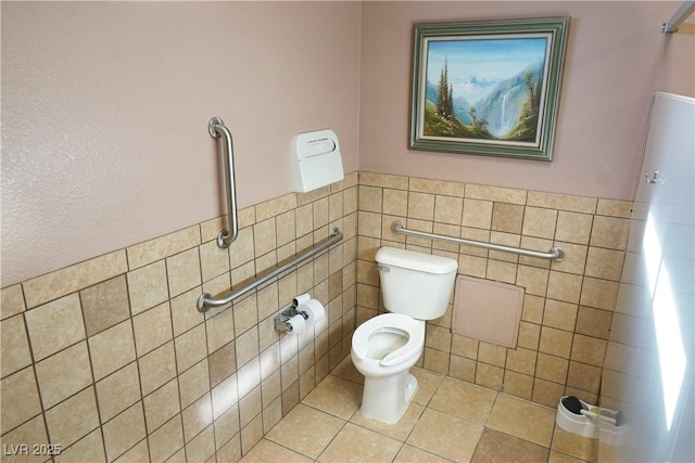 bathroom featuring tile walls, tile patterned floors, and toilet