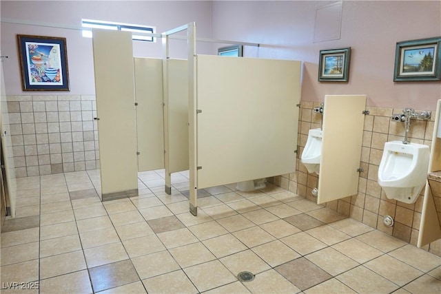 bathroom with tile patterned floors and tile walls