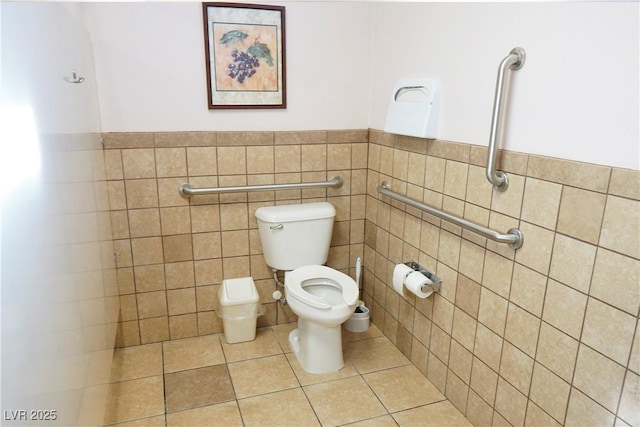 bathroom featuring tile patterned flooring, tile walls, and toilet