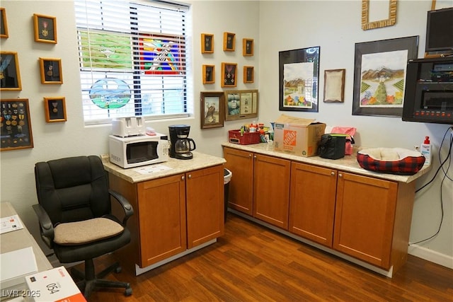 home office with dark hardwood / wood-style flooring