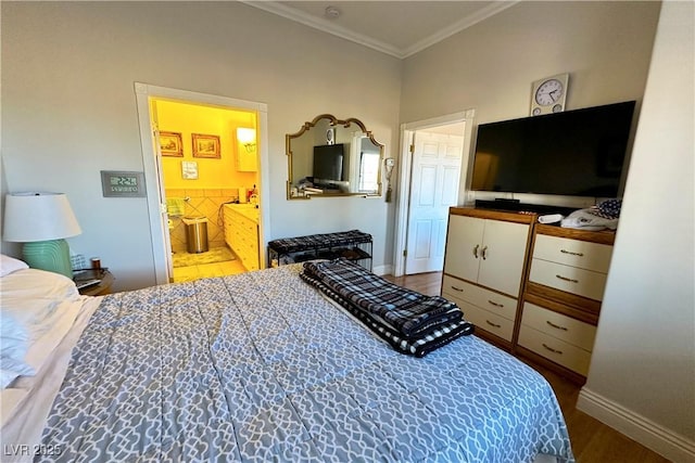 bedroom featuring crown molding, ensuite bath, and hardwood / wood-style flooring