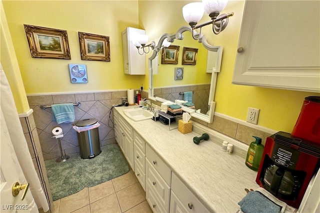 bathroom with tile walls, vanity, and tile patterned flooring