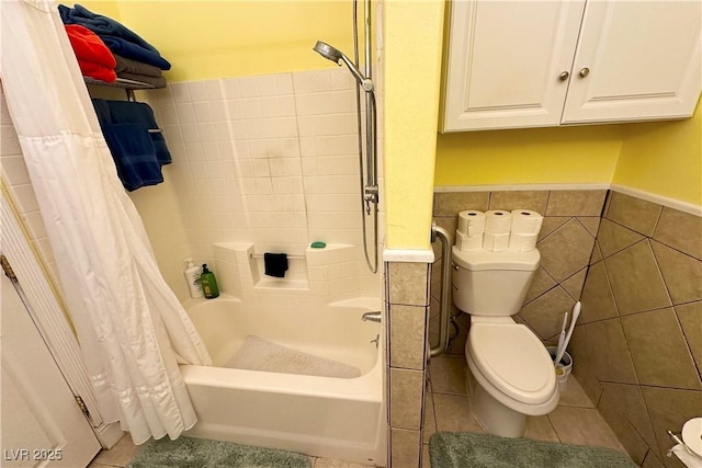 bathroom with shower / tub combo with curtain, toilet, tile patterned flooring, and tile walls