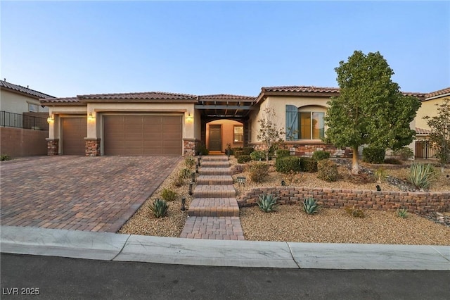 mediterranean / spanish-style house with a garage