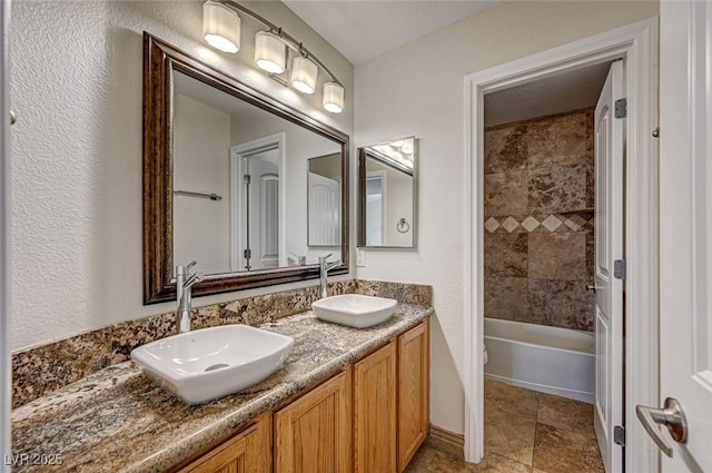 full bathroom featuring tiled shower / bath combo, vanity, tile patterned floors, and toilet