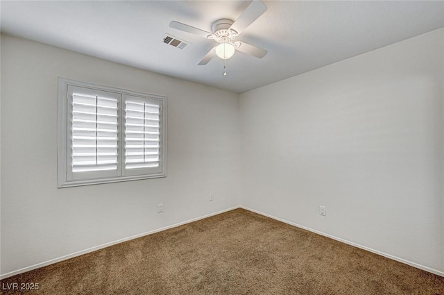 empty room with ceiling fan and carpet flooring