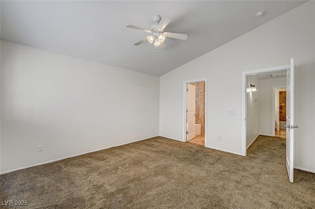 unfurnished bedroom with ceiling fan, carpet floors, ensuite bathroom, and vaulted ceiling