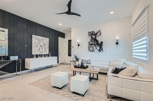 living area featuring a ceiling fan, recessed lighting, an accent wall, and wallpapered walls