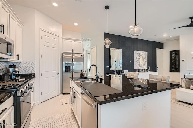 kitchen featuring sink, white cabinetry, hanging light fixtures, a center island with sink, and stainless steel appliances