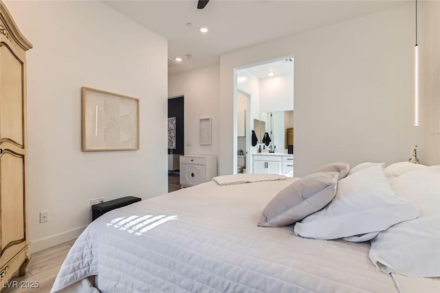 bedroom with light wood-type flooring and ensuite bath