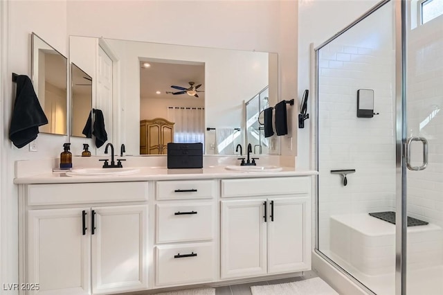 bathroom featuring an enclosed shower, vanity, and ceiling fan